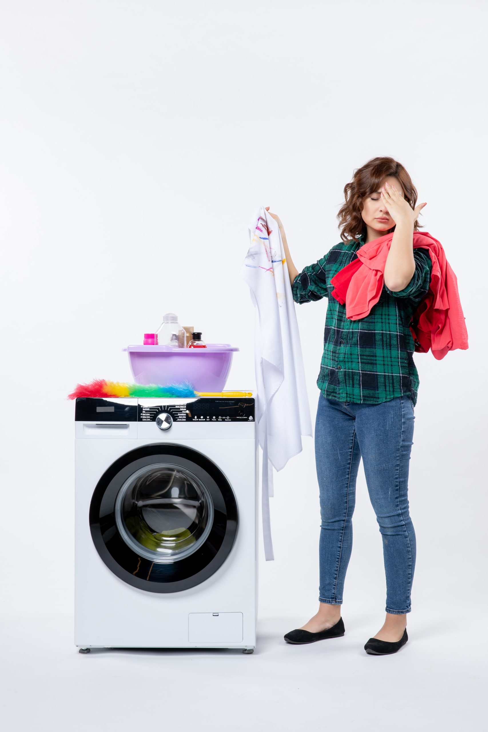 front view young female with washing machine preparing clothes wash white wall min scaled